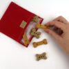 treat bag open with treats and hand red